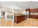 Open concept kitchen and dining area featuring stainless appliances, wood cabinets, and hardwood floors at 4616 Gold Finch Dr, Denver, NC 28037
