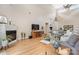 Open-concept living room with fireplace, hardwood floors, and a large sectional sofa at 4616 Gold Finch Dr, Denver, NC 28037