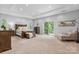 Spacious main bedroom features a tray ceiling, sitting area, and access to a private balcony at 4616 Gold Finch Dr, Denver, NC 28037