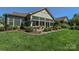 Backyard patio area with great landscaping, lush lawn and outdoor seating at 464 Granite Lake Ct, Denver, NC 28037