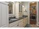 Elegant bathroom featuring double sinks, granite counters, vanity storage, and a walk-in closet at 464 Granite Lake Ct, Denver, NC 28037