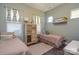 Cozy bedroom with twin beds, wood floors, an antique cabinet, and natural light at 464 Granite Lake Ct, Denver, NC 28037