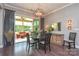 Dining area with elegant lighting fixtures, connecting to sunroom at 464 Granite Lake Ct, Denver, NC 28037