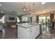 Open-concept kitchen with island flows into the living and dining areas at 464 Granite Lake Ct, Denver, NC 28037