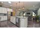 Stylish kitchen featuring stainless steel appliances and an island with seating at 464 Granite Lake Ct, Denver, NC 28037