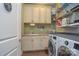 Well-equipped laundry room with cabinets, utility sink, washer, and dryer at 464 Granite Lake Ct, Denver, NC 28037