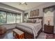 Spacious primary bedroom features hardwood floors, a decorative accent wall, and a cozy window seat at 464 Granite Lake Ct, Denver, NC 28037