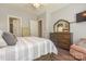 Bedroom with hardwood floors, neutral walls, a dresser with a decorative mirror, and a sitting chair at 464 Granite Lake Ct, Denver, NC 28037