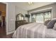 Bedroom featuring a window seat, hardwood floors, and a dresser with a decorative mirror at 464 Granite Lake Ct, Denver, NC 28037