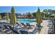 Inviting community pool and lounge area with chairs and yellow striped umbrellas at 464 Granite Lake Ct, Denver, NC 28037
