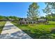 Community pool area with lounge chairs, umbrellas, green space, and sidewalks on a clear day at 464 Granite Lake Ct, Denver, NC 28037