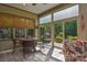 Enclosed screened patio with tile flooring features sliding doors leading to a landscaped yard at 464 Granite Lake Ct, Denver, NC 28037