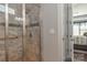 Tiled glass shower enclosure with bench and showerhead in modern, updated bathroom at 464 Granite Lake Ct, Denver, NC 28037