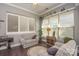 Bright sunroom features plantation shutters, neutral walls, and hardwood floors at 464 Granite Lake Ct, Denver, NC 28037