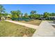 Tennis court surrounded by sidewalks, green grass, and trees in a nice community at 464 Granite Lake Ct, Denver, NC 28037