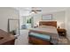 A comfortable main bedroom featuring a bed, dresser, large mirror, and a ceiling fan for added comfort at 4916 Ritchie Rd, Lincolnton, NC 28092