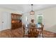 Cozy dining room with wood flooring, traditional hutch, and ample natural light at 4916 Ritchie Rd, Lincolnton, NC 28092