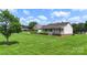 Ranch-style home with covered porch, mature trees, and landscaping on a lush green lawn at 4916 Ritchie Rd, Lincolnton, NC 28092