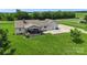 Backyard view of home with deck, patio, concrete pad, green lawn and mature trees at 4916 Ritchie Rd, Lincolnton, NC 28092