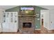 Stone fireplace with a mounted TV and decorative cabinet offering a cozy focal point in the living room at 4916 Ritchie Rd, Lincolnton, NC 28092