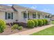 Charming front porch with vintage decorations and green shutters, complemented by lush landscaping at 4916 Ritchie Rd, Lincolnton, NC 28092