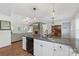 Bright and open-concept kitchen with granite countertops flowing into the living room with a stone fireplace at 4916 Ritchie Rd, Lincolnton, NC 28092