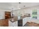 Bright kitchen featuring granite counters, an island, and sleek black appliances, offering a modern culinary space at 4916 Ritchie Rd, Lincolnton, NC 28092