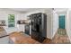 Well-lit kitchen featuring black appliances, white cabinets, and wood-look flooring for a clean, modern design at 4916 Ritchie Rd, Lincolnton, NC 28092