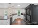 Modern kitchen with sleek black appliances, white cabinetry, and spacious countertops at 4916 Ritchie Rd, Lincolnton, NC 28092