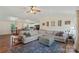 Bright living room with a large sectional sofa, area rug, fireplace, and view of the open-concept kitchen and dining area at 4916 Ritchie Rd, Lincolnton, NC 28092