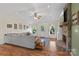 Spacious living room featuring a stone fireplace, TV, ceiling fan, and a comfortable sectional sofa with natural light at 4916 Ritchie Rd, Lincolnton, NC 28092