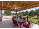 Spacious covered patio with outdoor seating, fan, grill, and view of the backyard at 4916 Ritchie Rd, Lincolnton, NC 28092