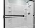 Modern walk-in shower with black hardware and built-in storage shelves at 4916 Ritchie Rd, Lincolnton, NC 28092
