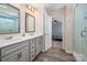 Bathroom with a double sink vanity, tile flooring, framed mirrors, and a glass-enclosed shower area at 5014 Forest Hills Pl, Fort Mill, SC 29707