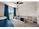 Well-lit bedroom featuring a ceiling fan, window with blue curtains, and a bed at 5014 Forest Hills Pl, Fort Mill, SC 29707