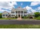 Grand clubhouse boasts stately columns, manicured landscaping, and ample parking for residents and guests at 5014 Forest Hills Pl, Fort Mill, SC 29707