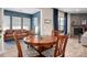 Dining room features wood table and chairs near windows and stone fireplace at 5014 Forest Hills Pl, Fort Mill, SC 29707