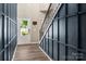 Welcoming entryway with hardwood floors, coat hooks, and blue accent wall with view to the front door at 5014 Forest Hills Pl, Fort Mill, SC 29707