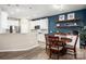 Eat-in kitchen with white cabinets, stainless steel appliances, bar seating and wood table with seating at 5014 Forest Hills Pl, Fort Mill, SC 29707