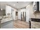 Well-lit kitchen with stainless appliances, granite countertops, and wood-look flooring at 5014 Forest Hills Pl, Fort Mill, SC 29707