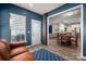Open concept living area with dining and kitchen access, hardwood floor, and big windows at 5014 Forest Hills Pl, Fort Mill, SC 29707