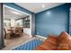 Bright living room flows into the dining area with wood flooring, blue accent wall, and comfortable seating at 5014 Forest Hills Pl, Fort Mill, SC 29707