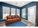 Living room features a leather sofa, carpet, a door to the outside, and lots of light at 5014 Forest Hills Pl, Fort Mill, SC 29707