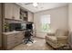 Bright home office with custom built-ins, computer setup, comfortable chair, and natural light from the window at 5014 Forest Hills Pl, Fort Mill, SC 29707