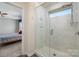 Tiled shower showcasing a glass door, window, and a rainfall showerhead offering a spa-like experience at 5014 Forest Hills Pl, Fort Mill, SC 29707