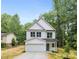 Charming two-story home with a white exterior, garage, and well-manicured lawn at 515 Dixie Dr, Mooresville, NC 28115