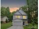 Charming two-story home featuring white siding, attached garage and a welcoming front porch at 515 Dixie Dr, Mooresville, NC 28115