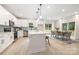 Open kitchen and dining area with stainless steel appliances, an island with seating, and ample natural light at 515 Dixie Dr, Mooresville, NC 28115