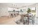 Bright kitchen featuring an island with bar seating, stainless appliances and adjacent dining area with backyard views at 515 Dixie Dr, Mooresville, NC 28115