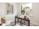 Sunlit office space with a wooden desk, large window, and neutral decor at 515 Dixie Dr, Mooresville, NC 28115